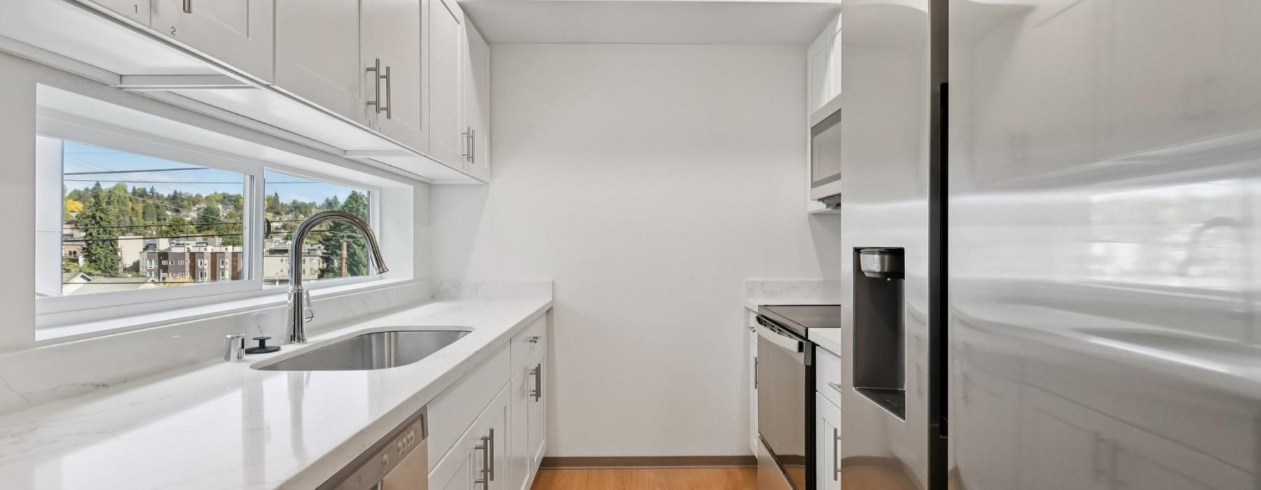 a kitchen with white cabinets