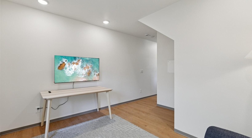a room with a table and a painting on the wall