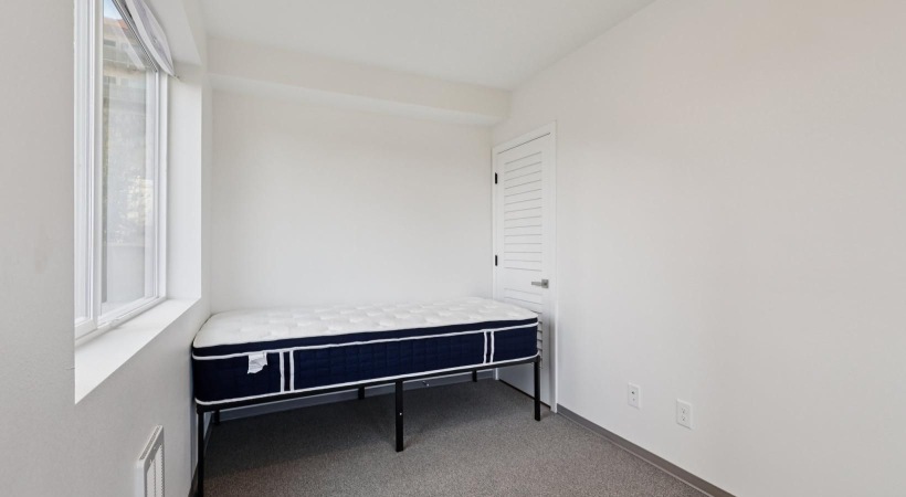 a room with a bed and a window
