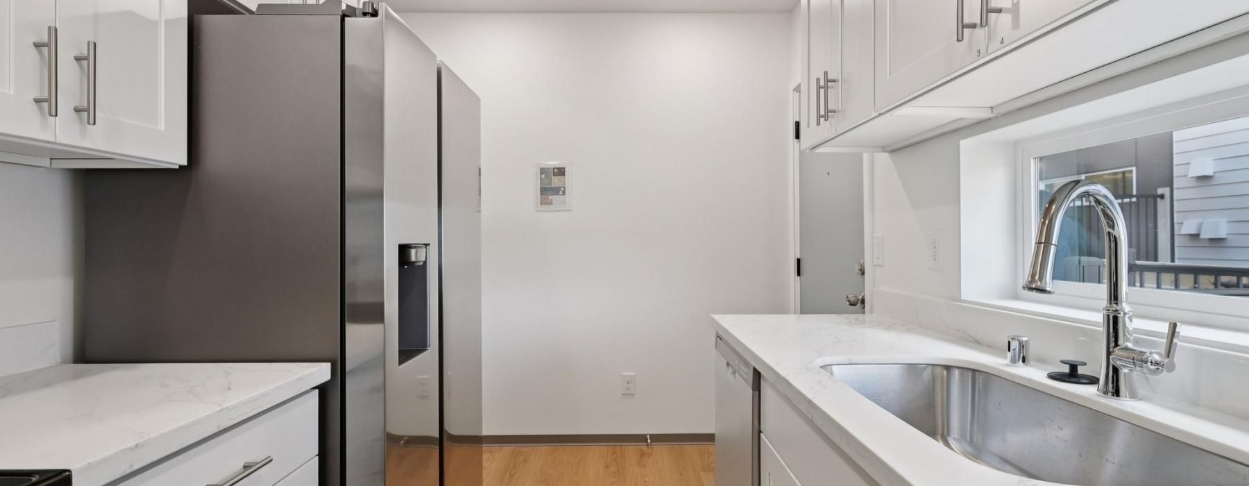 a kitchen with white cabinets